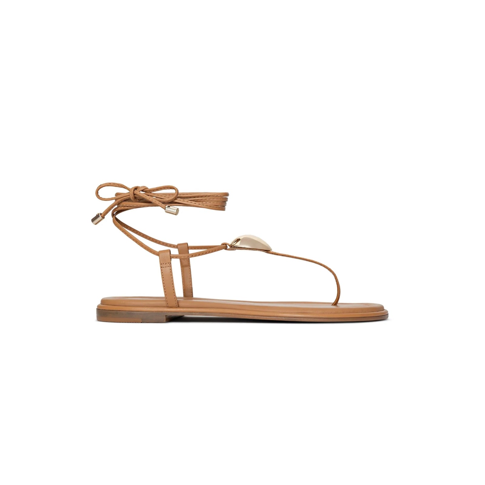 Tan sandal with thin straps on a white background