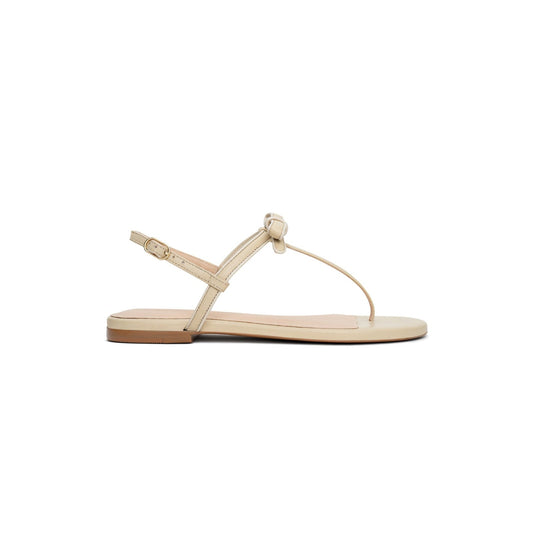 Beige sandal with a flat sole on a white background