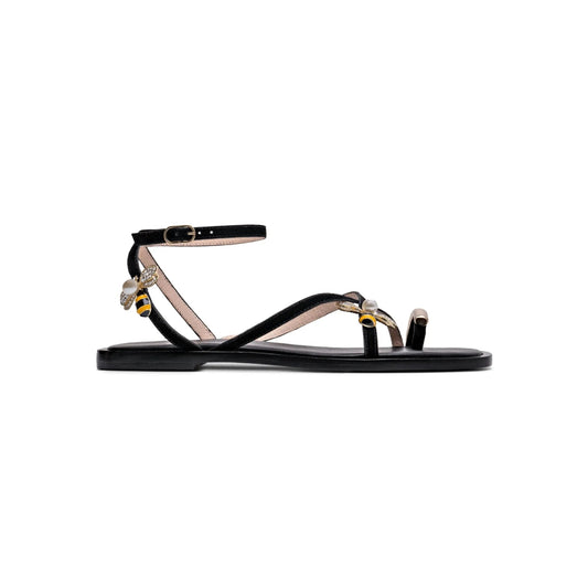 Black sandal with bee embellishments on a white background