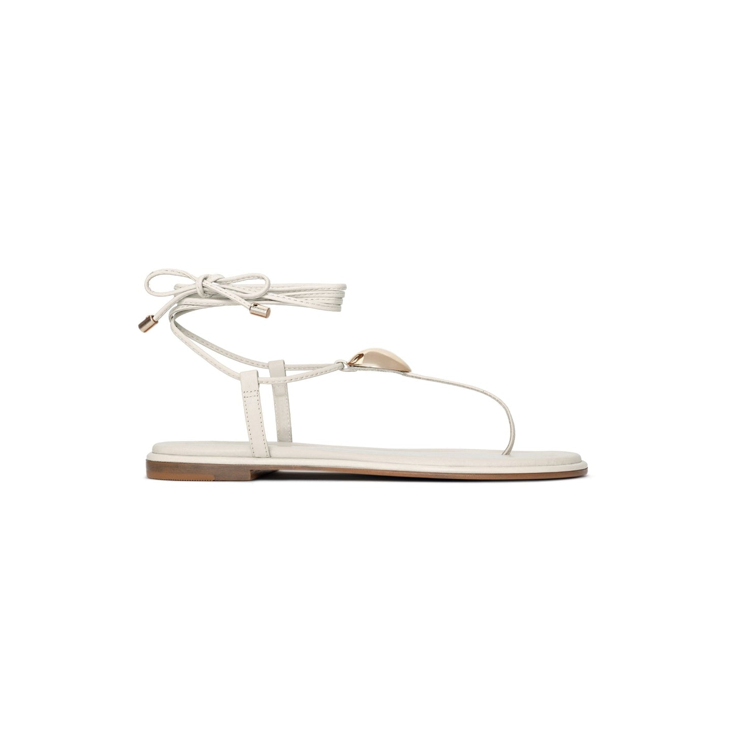 White sandal with thin straps on a white background