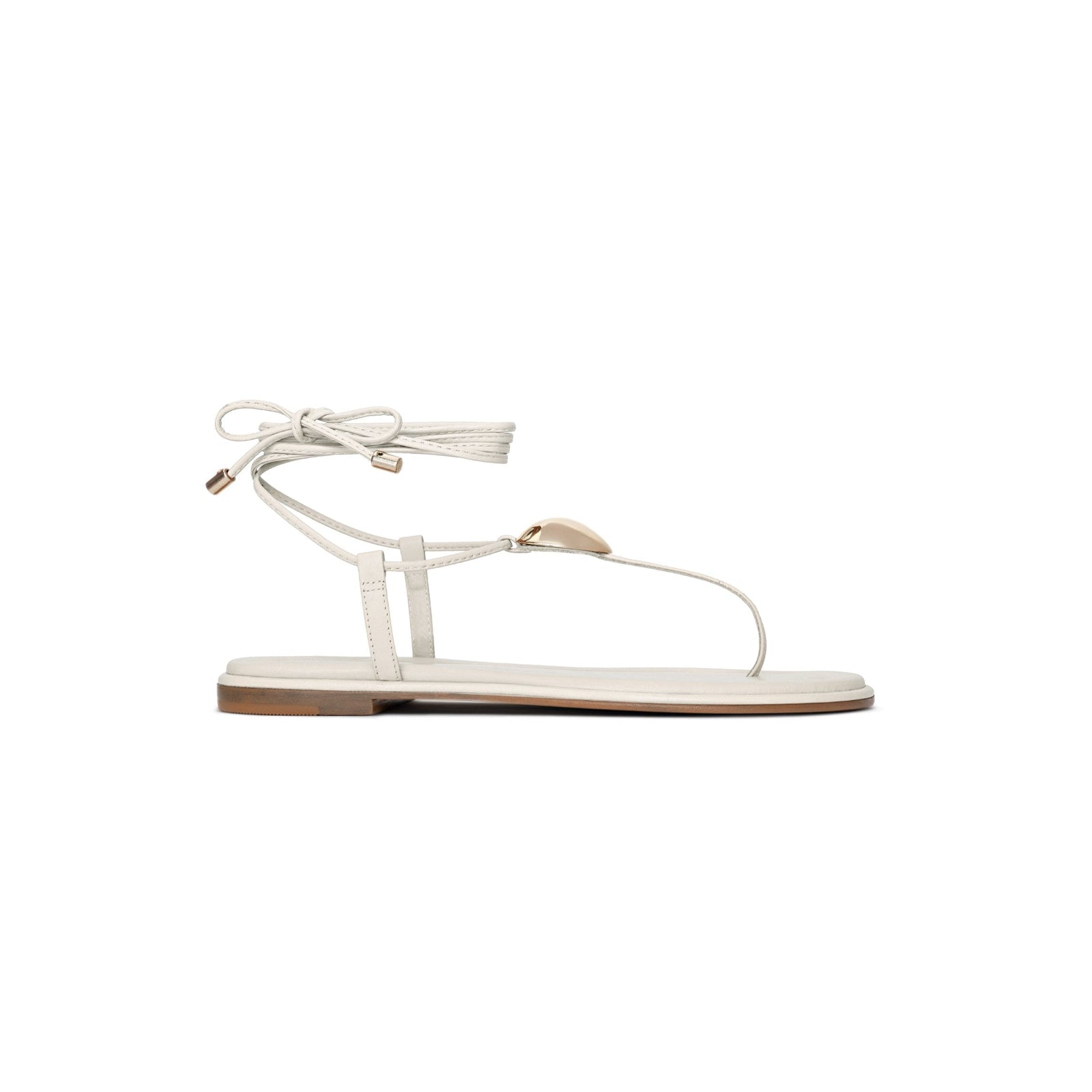White sandal with thin straps on a white background